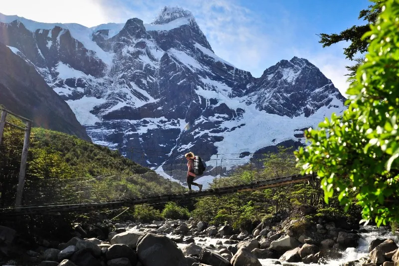 Hiker on the W Trek crossing a bridge